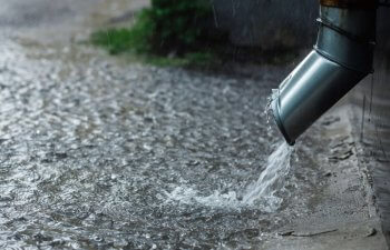 rain coming out of a gutter downspout