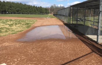 water ponded up on the school baseball field due to poor drainage