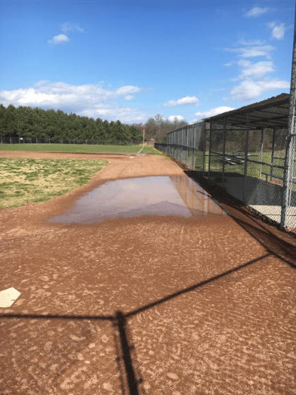 water ponded up on the school baseball field due to poor drainage