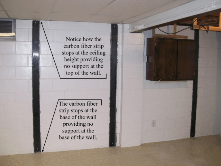 a basement wall with badly installed carbon fiber strips