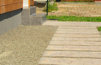 waterproofing house foundation with stone pathway
